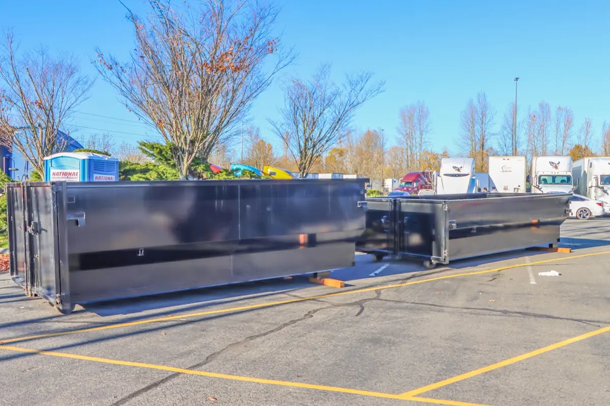 Professional dumpster rental service with roll-off container on residential driveway in Fort Stewart